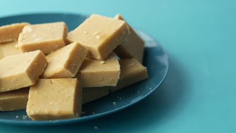 close up of indian sweet in a bowl on table.