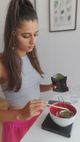 young woman preparing matcha drink