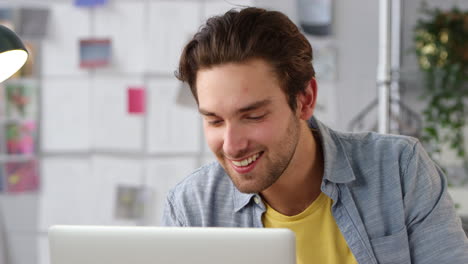 close up of male student or business owner working in fashion using laptop in studio