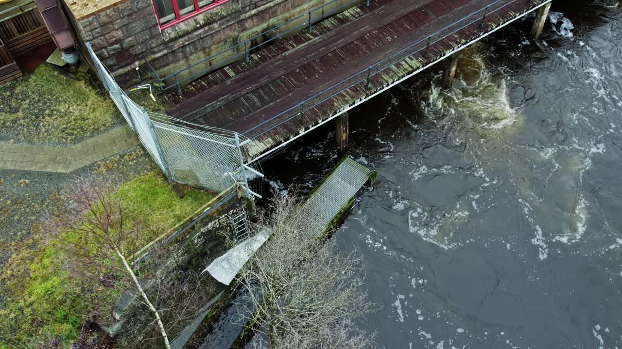Aerial view of river and historic building in Jonsered, Sweden, winter vibes