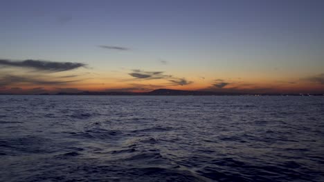 romantic sunset as seen from a sailboat in the tyrrhenian sea by the port of naples, italy