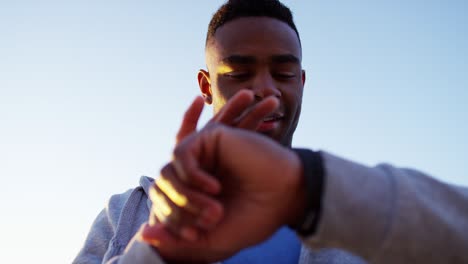 healthy african american male exercising wearing smart watch