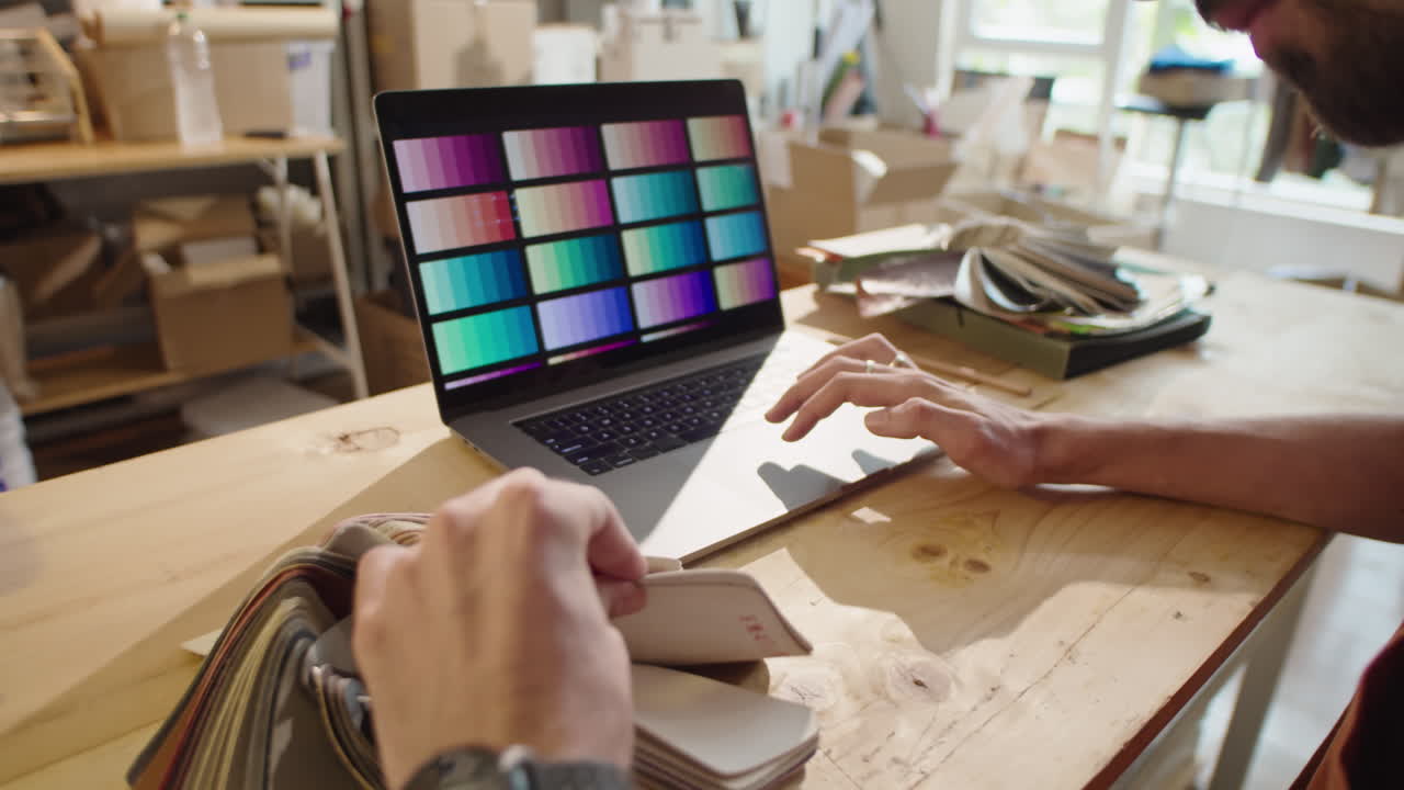 Designer Choosing Color and Material with Laptop and Palette