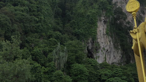 murugan statue against limestone hill batu caves malaysia