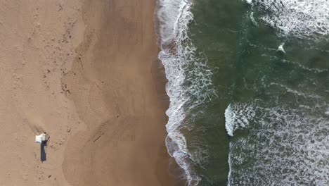 ocean waves stanwell park beach birdseye aerial drone cliffside sunny lifeguard tower morning daytime creek surf wollongong nsw australia sydney south coast illawarra coalcliff throull forward motion