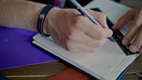 male hands drawing sketch in notebook. man drawing line with pencil and ruler