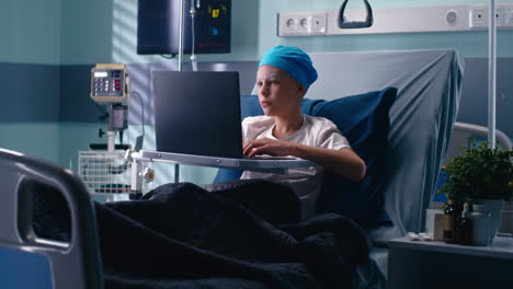 boy using laptop in hospital bed
