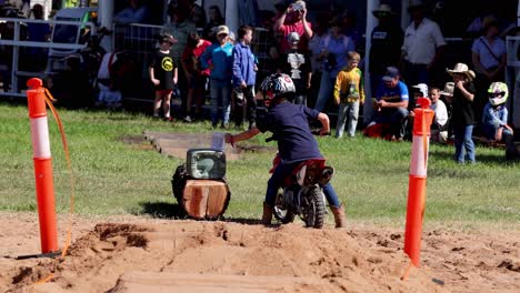 child riding mini bike around obstacles