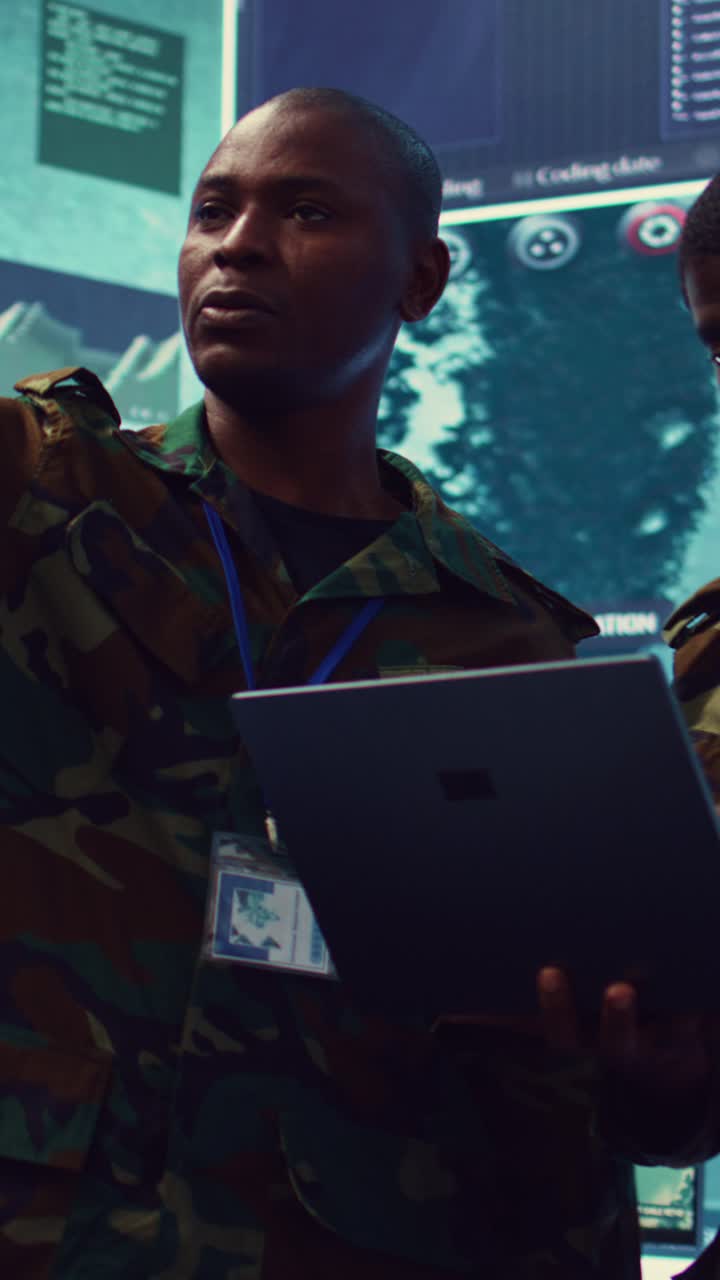 African Soldiers Discussing Data in High-Tech Command Center