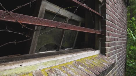 abandoned building with broken window and rusty bars