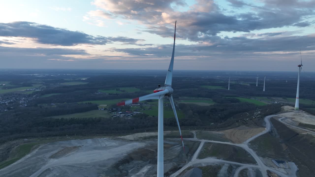 wind tubrine, aerial view. sunset, clean green energy. Germany. energy transistion, turning blades, close up view.