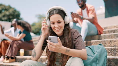 friends relaxing outdoors with smartphones and headphones