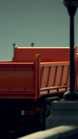 a red dump truck parked on a city street