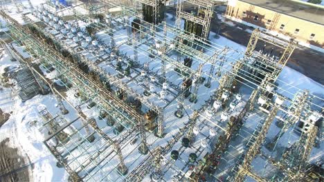 aerial drone powerlines merging together at substation