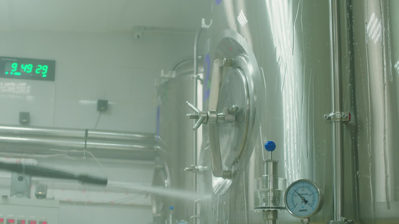 Craft beer production, general cleaning on factory, brewery manufacture. Washing metal vats bottles. Brewing, cooking alcohol