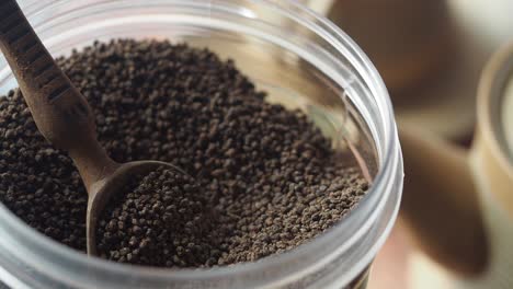 loose leaf tea in a container with a wooden spoon