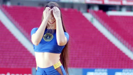 Beautiful-Brazilian-football-fan-plays-with-hair-in-stadium