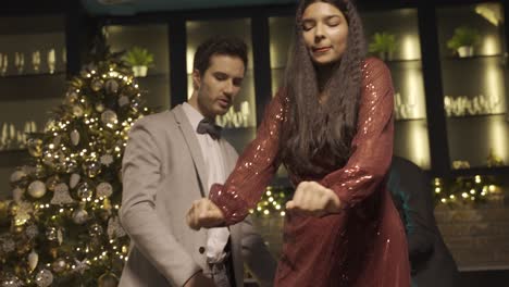 a couple dressed in elegant clothes dance at the new year's party