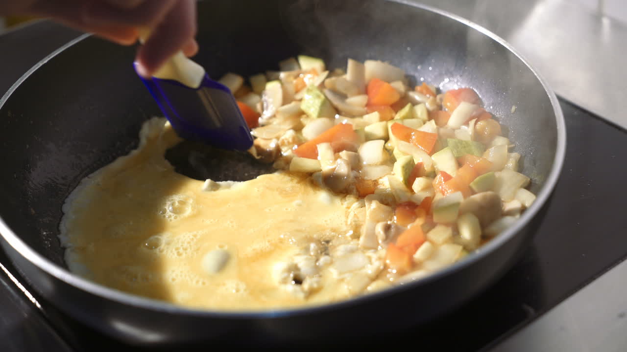 Stewed sliced vegetables in pan. Fried mushrooms with vegetables in frying pan
