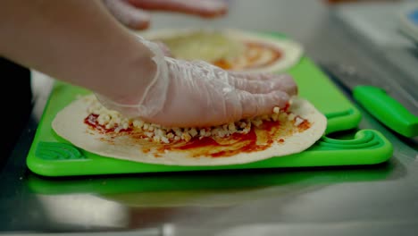 cu cook prepares the wok puts the cheese on a red sauce