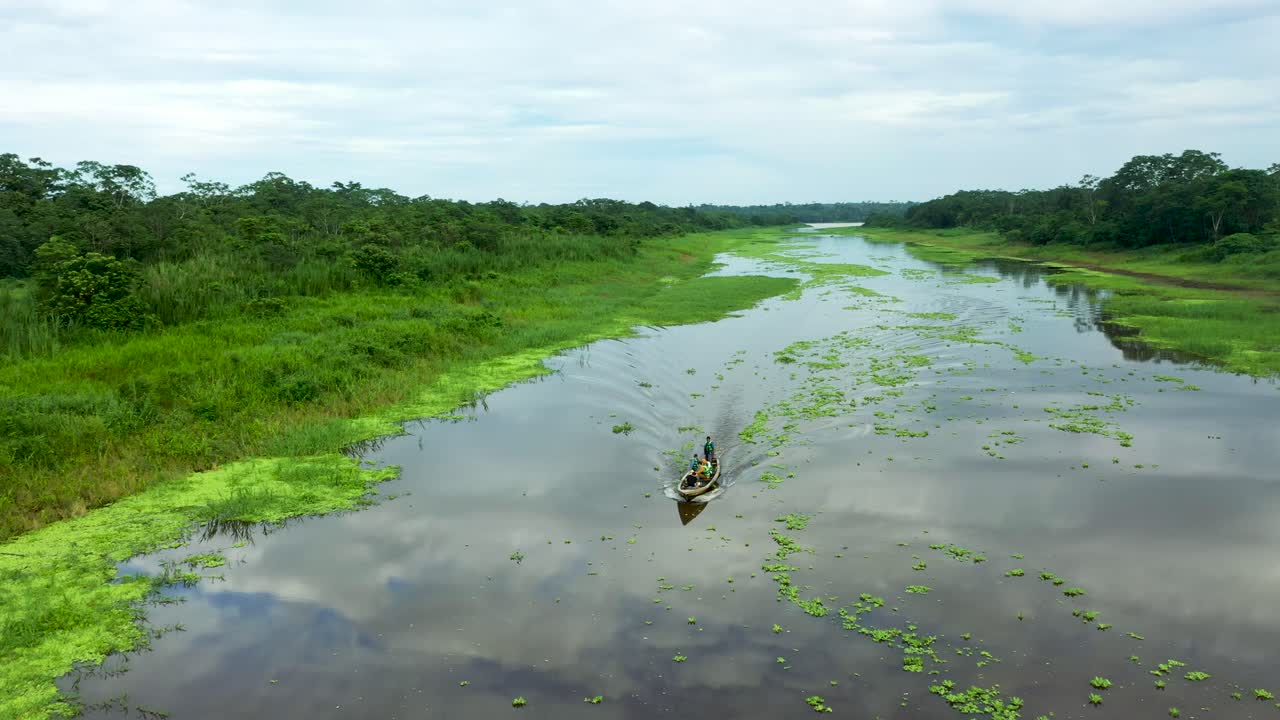 barco que viaja en el hermoso río amazonas con un exuberante paisaje de selva tropical peruana en el fondo - antena