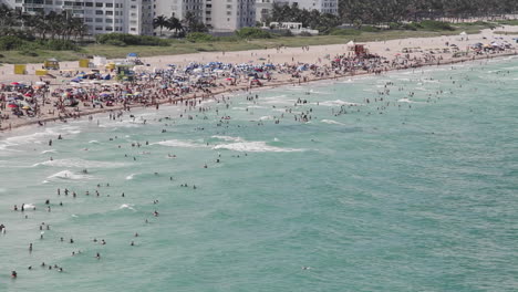 wide shot miami florida extremely crowded baches from the pov from a cruise ship