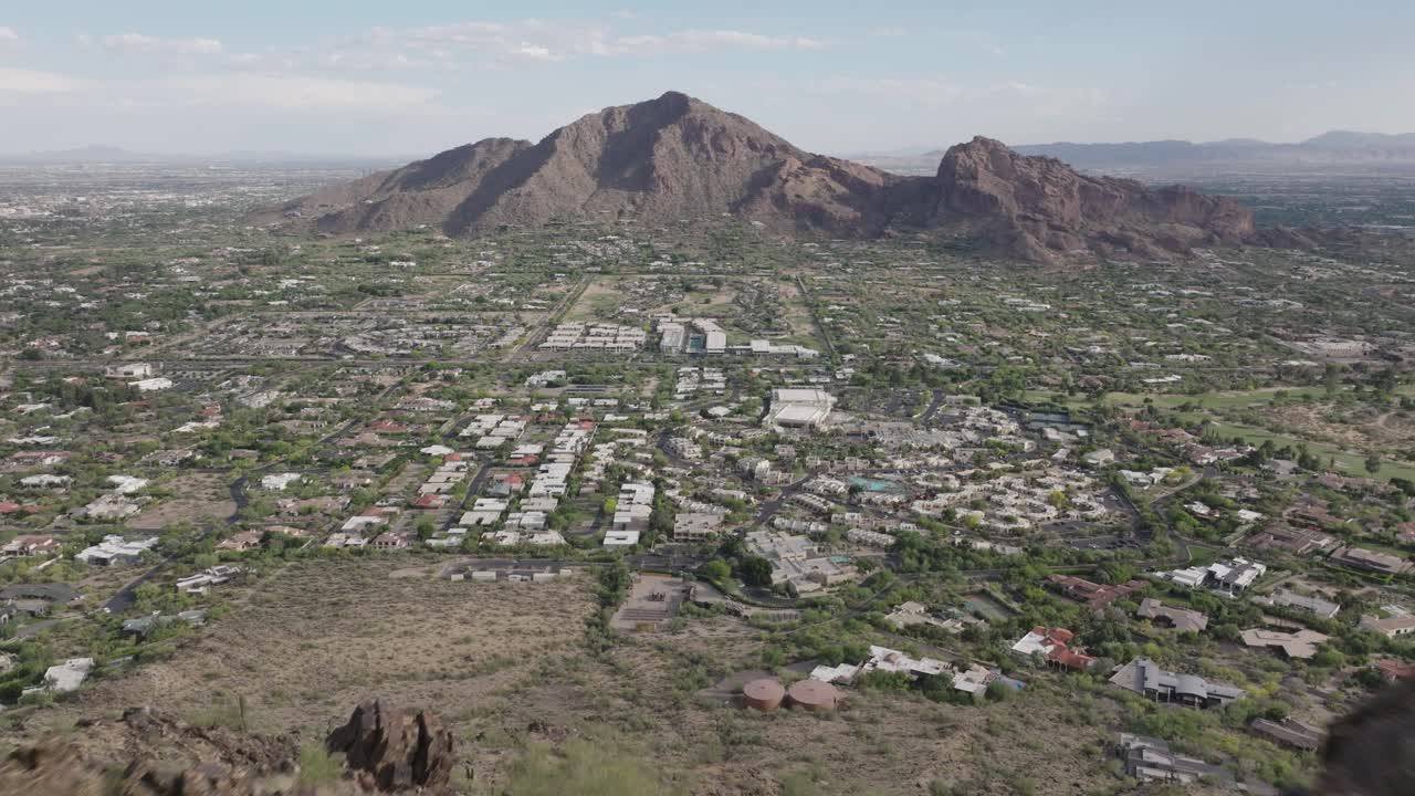 Drone flying over Mummy mountain capturing Paradise valley of Arizona and camelback mountain at background in USA