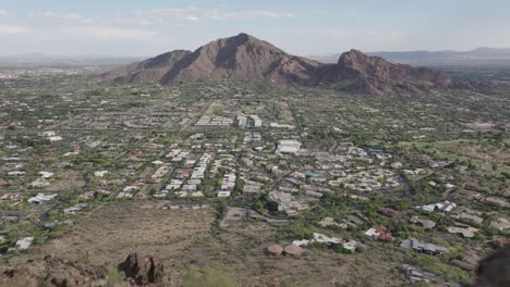 Drone-flying-over-Mummy-mountain-capturing-Paradise-valley-of-Arizona-and-camelback-mountain-at-background-in-USA