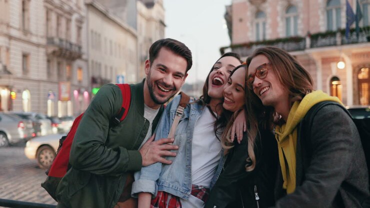 Caucasian group of friends together in the street and smiling at the camera