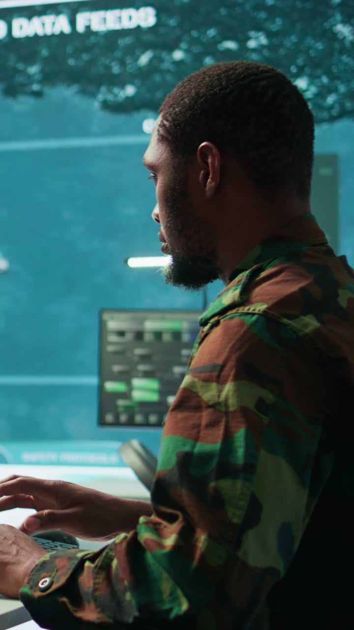 Vertical Video Military specialist in high tech control center managing satellite surveillance