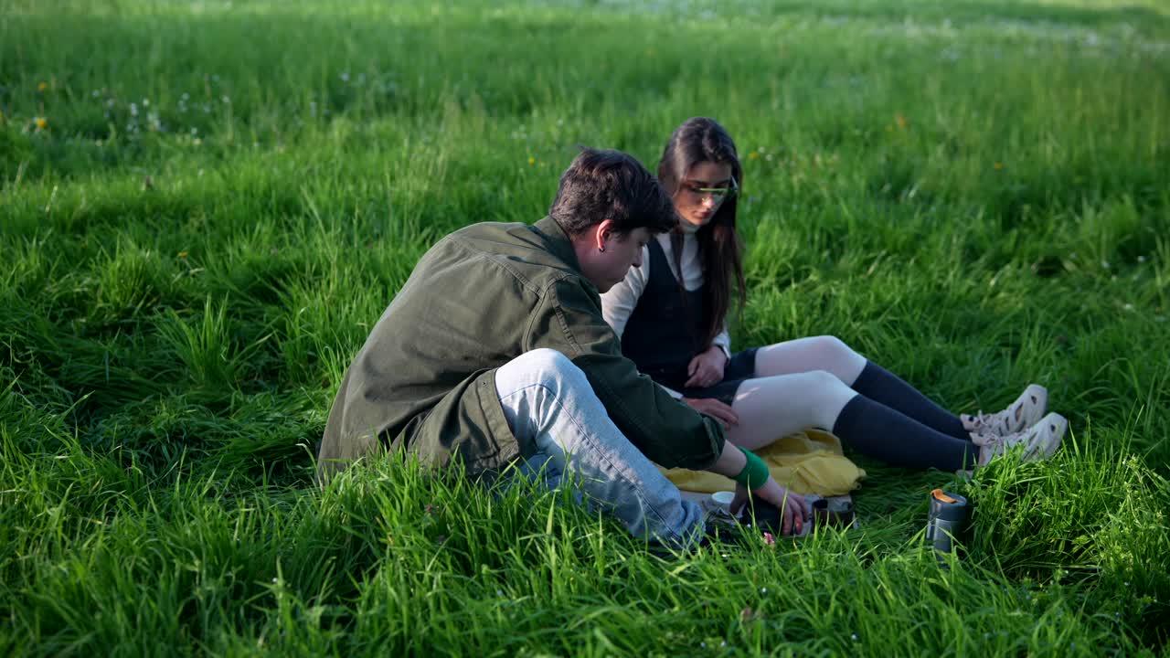 Couple enjoying a picnic in a grassy field