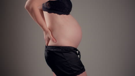 woman with back pain during advanced pregnancy