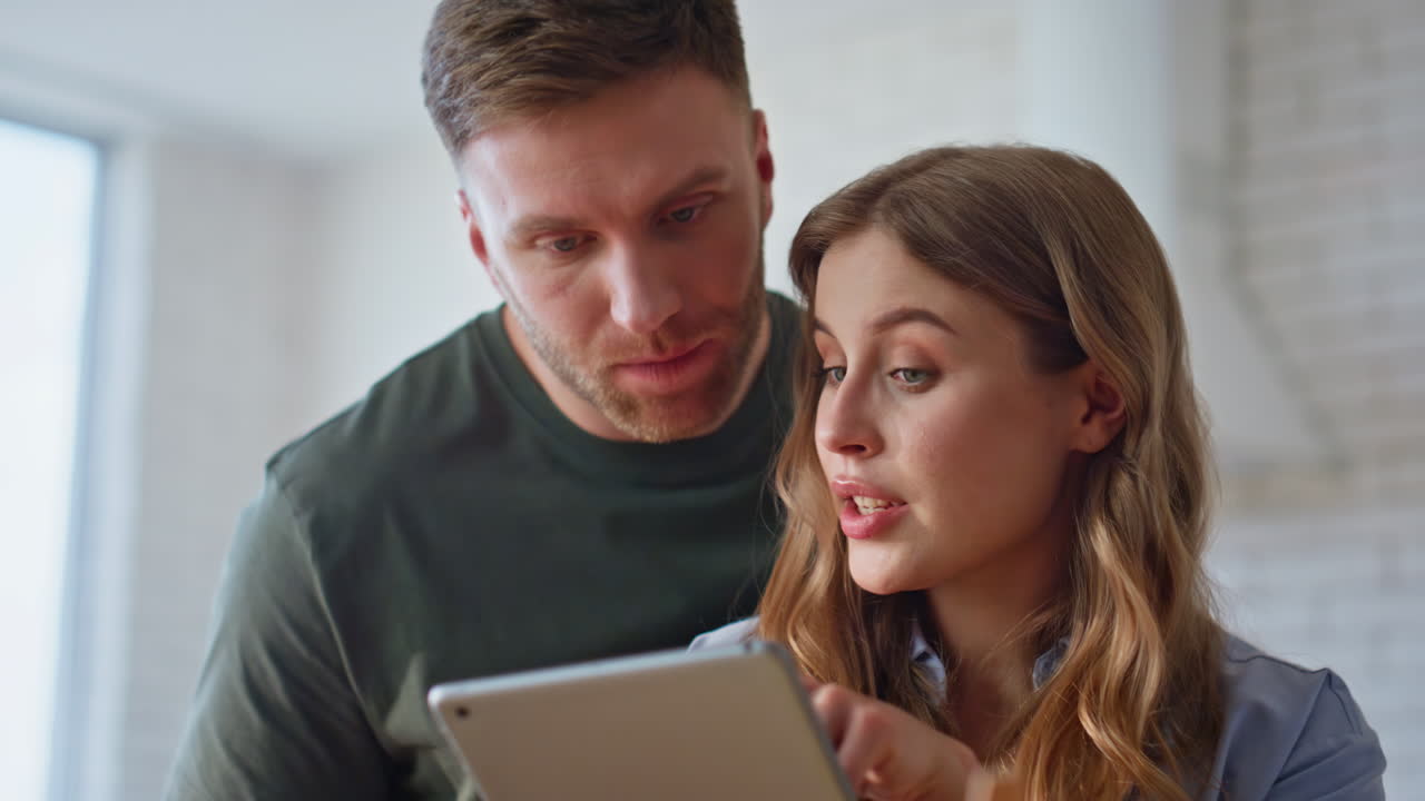 Sweethearts hands using tablet searching recipe kitchen closeup. Lovers cooking
