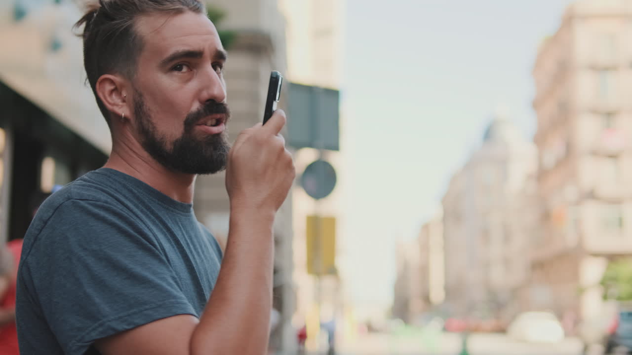 Uomo che per mezzo dello smartphone sulla via della città