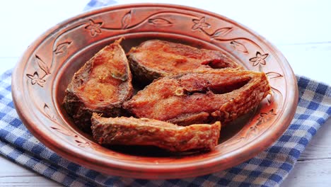 Close-up-of-cooked-ilsha-fish-on-plate-on-table-,