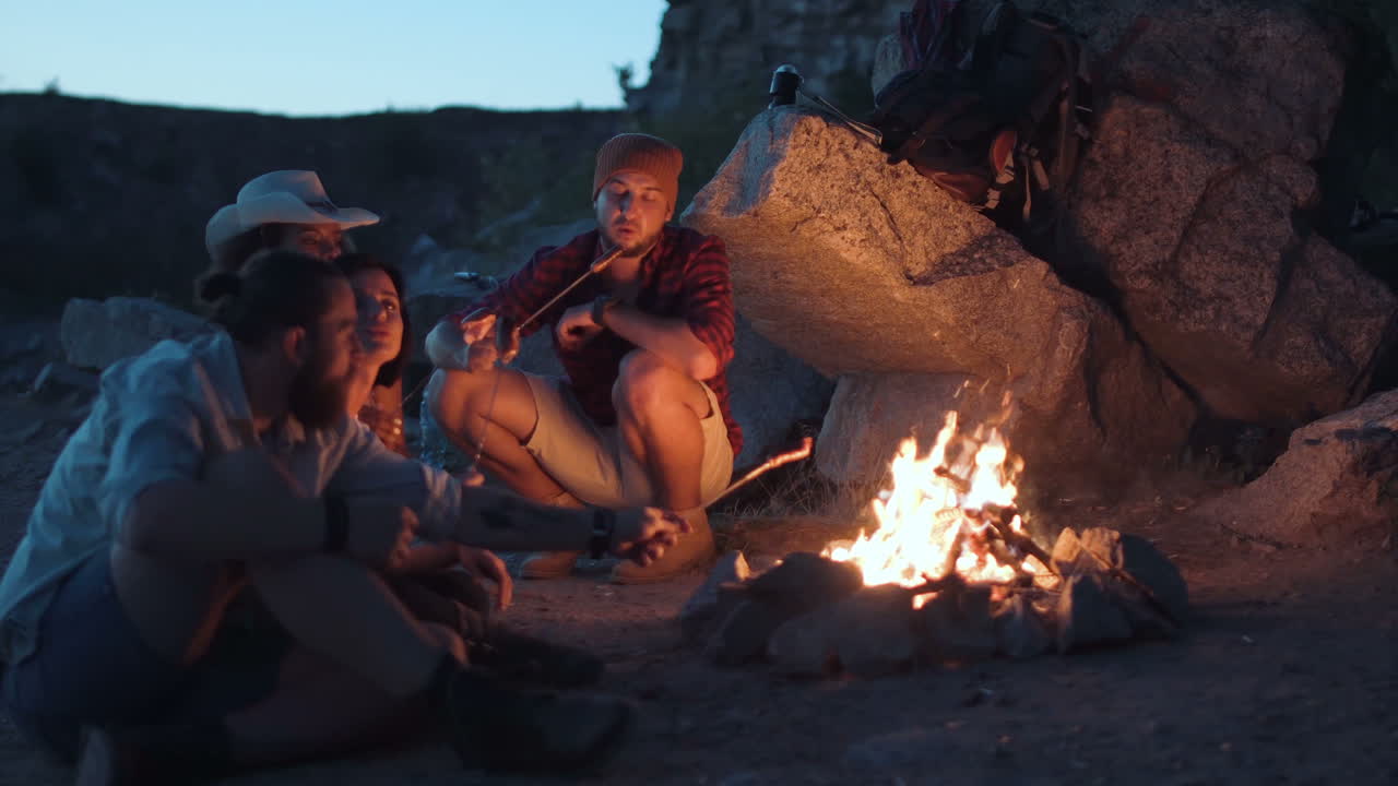 Friends Gather Around a Campfire at Night