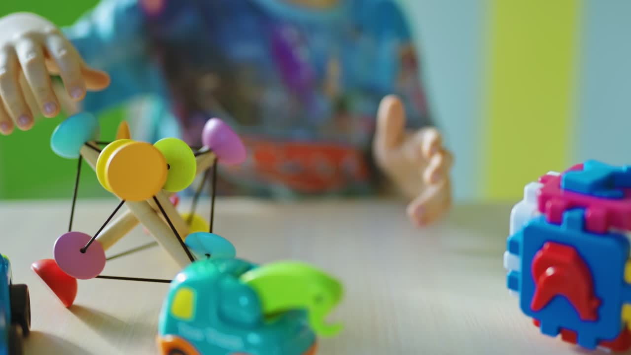 Boy sitting next to toy. Kid boy playing with toys indoors