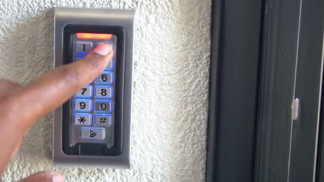 Person using a digital keypad door lock.