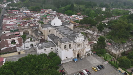 rotating aerial footage of the crumbling facade of a cathedral that slowly moves in over the roof in antigua, guatemala