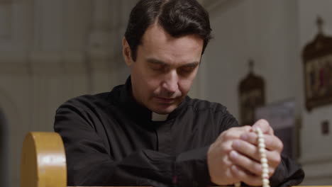 priest holding a rosary