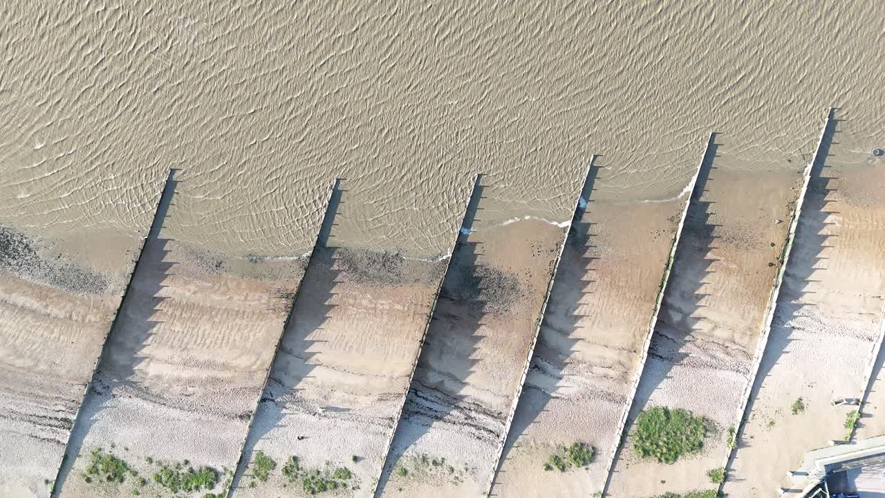 Groins on beach West Mersea Essex UK Overhead birds eye drone aerial view