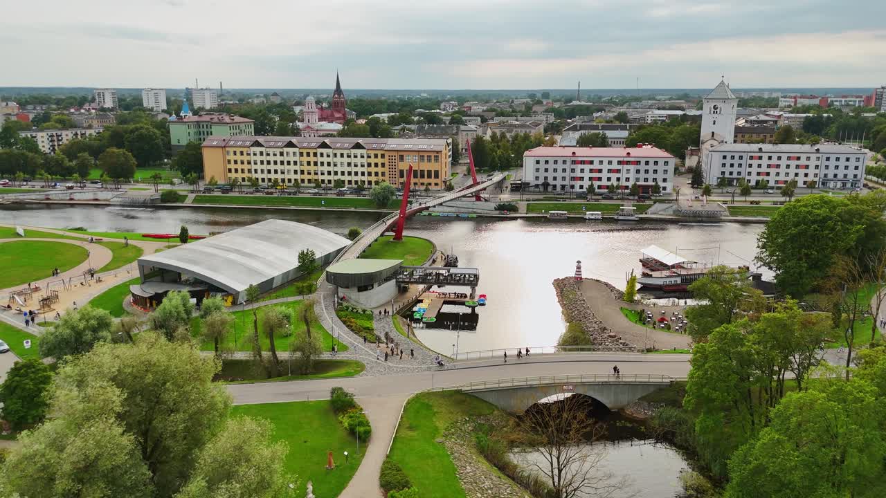 Drone shot of Jelgava river, pedestrian bridge and city architecture in Latvia