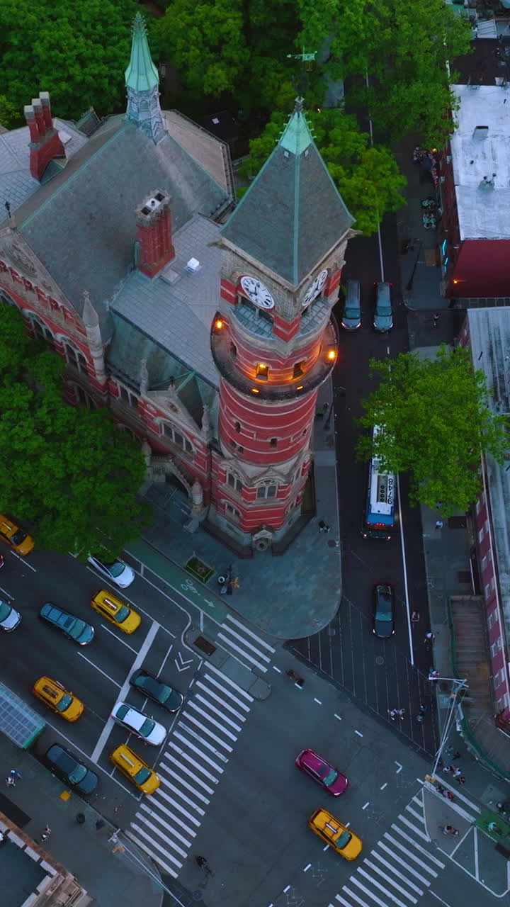 Many cars stopped at the crossroads waiting their turn to move. Busy traffic streets of New York at daytime from top view. Vertical video