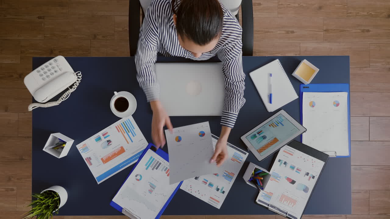 Top view of accountant woman typing marketing strategy on computer