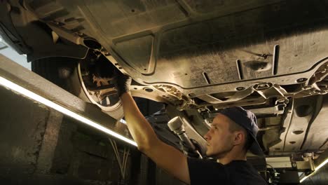 car suspension test at automobile service. inspection of the undercarriage of the car in the auto service. repair and maintenance of the car in service.