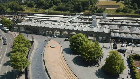 Drone-shot-of-people-arriving-at-Sheffield-Train-Station-on-a-bright-summers-day