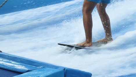 person surfing in an indoor wave pool