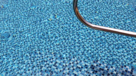 beach ball in pool. colorful inflatable ball floating in swimming pool, summer vacation concept.