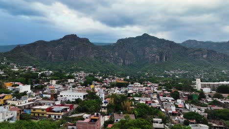 drone shot rising over the colorful townscape of the tepoztlan village in mexico