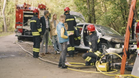 firefighters respond to a car accident in the woods